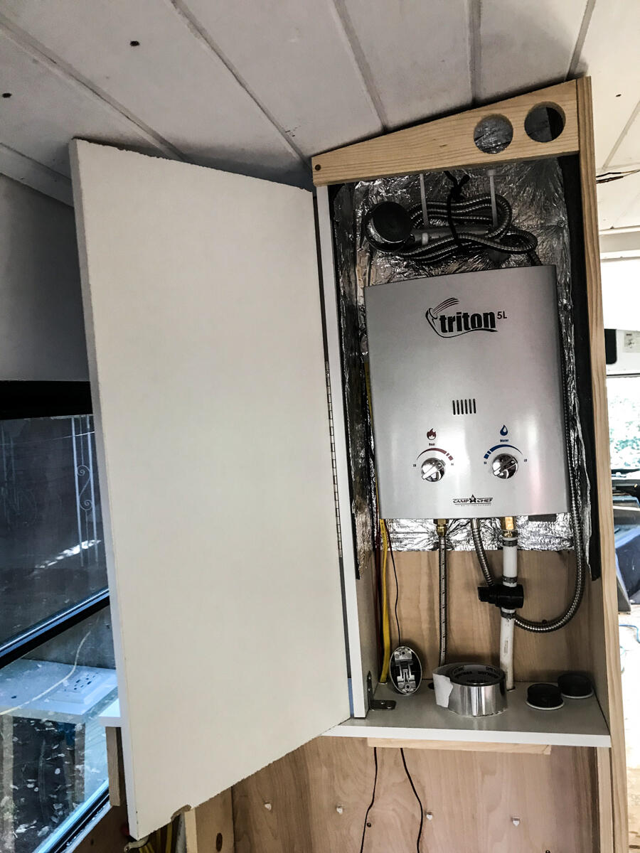 Hot Water Heater in Cabinet with Lines to Propane and Water Pump